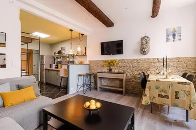 a living room with a couch and a table at Comfortable apartment in the heart of Suquet in Cannes