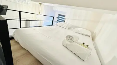 a bed with white sheets and towels on it at Croisette Studio, Palais des Festivals and Beach in Cannes