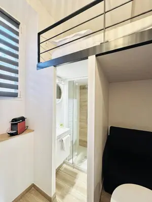 a bedroom with a bunk bed and a bathroom at Croisette Studio, Palais des Festivals and Beach in Cannes