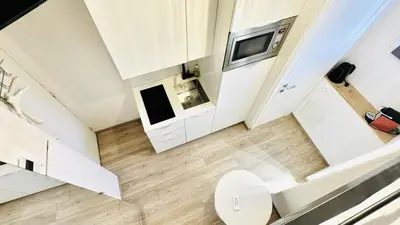 an overhead view of a small white bathroom with a toilet at Croisette Studio, Palais des Festivals and Beach in Cannes