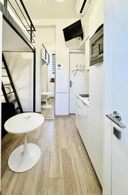 a kitchen with a white table and a white refrigerator at Croisette Studio, Palais des Festivals and Beach in Cannes