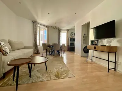 a living room with a couch and a table at Newly renovated 3-rooms apartment in the heart of old Cannes, up to 6 persons in Cannes