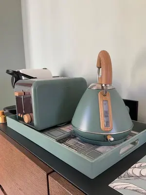 a tea kettle and toaster on a tray on a table at Newly renovated 3-rooms apartment in the heart of old Cannes, up to 6 persons in Cannes