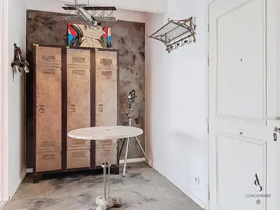 a room with a table in front of a wall at Le Félix - 4 pers 66 m2 - Vieux port - Climatisation in Cannes