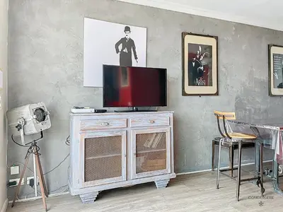 a television sitting on top of a cabinet in a room at Le Félix - 4 pers 66 m2 - Vieux port - Climatisation in Cannes