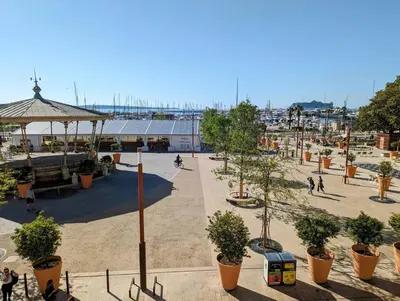 a park with trees in pots and a building at Le Félix - 4 pers 66 m2 - Vieux port - Climatisation in Cannes