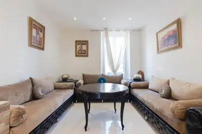 a living room with a couch and a table at Charmant appartement à 5min du Palais des Festivals in Cannes