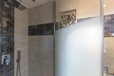 a shower with a glass door in a bathroom at Charmant appartement à 5min du Palais des Festivals in Cannes