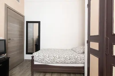a bedroom with a bed and a mirror and a door at Charmant appartement à 5min du Palais des Festivals in Cannes