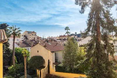 a view of a city with palm trees and houses at Charmant appartement à 5min du Palais des Festivals in Cannes