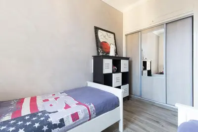 a small bedroom with a bed and a window at Charmant appartement à 5min du Palais des Festivals in Cannes