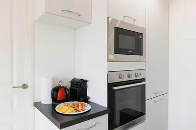 a kitchen with a plate of food and a microwave at Cannes Beach - Vue Mer-Plage-Piscine-Clim-Wifi in Cannes