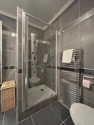 a bathroom with a shower and a toilet and a sink at Studio Victoria 200 m Carlton Hotel & Croisette in Cannes