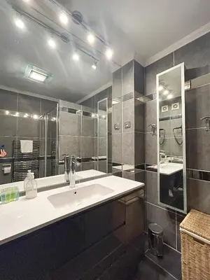 a bathroom with a sink and a large mirror at Studio Victoria 200 m Carlton Hotel & Croisette in Cannes