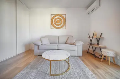 a living room with a couch and a table at Lumineux studio LOGGIA, Alexandre III- proche CROISETTE A0B203 in Cannes