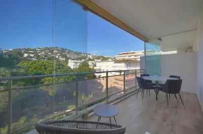 a room with a balcony with a table and chairs at Lumineux studio LOGGIA, Alexandre III- proche CROISETTE A0B203 in Cannes