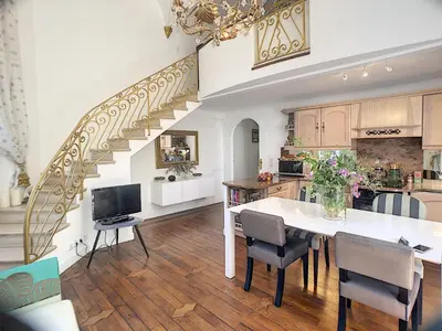 a kitchen with a dining table and a staircase at Charmant appartement en duplex 288L in Cannes