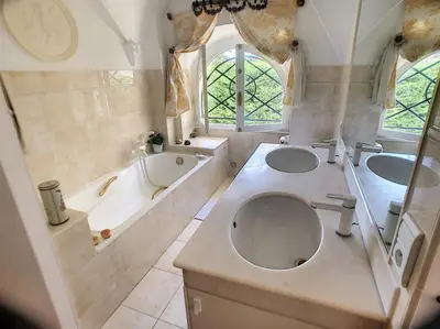 a bathroom with two sinks and a toilet and a tub at Charmant appartement en duplex 288L in Cannes