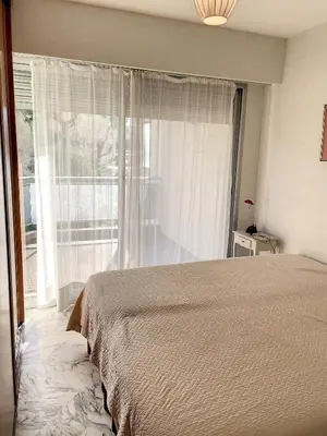 a bedroom with a bed and a large window at A deux pas des plages du Midi 305L in Cannes