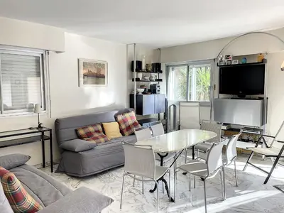 a living room with a couch and a table at A deux pas des plages du Midi 305L in Cannes