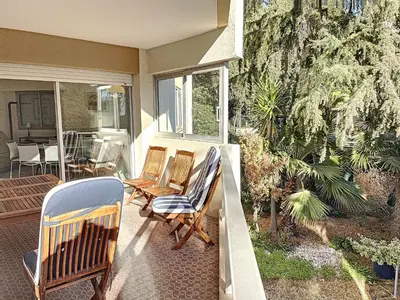a porch with two chairs and a table on a house at A deux pas des plages du Midi 305L in Cannes