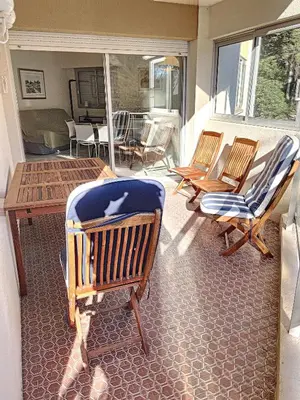 a porch with chairs and a table and a table at A deux pas des plages du Midi 305L in Cannes