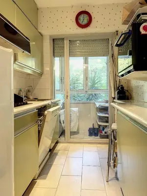 a kitchen with a sink and a window with a clock at A deux pas des plages du Midi 305L in Cannes