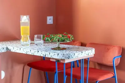 a living room with a couch and two colorful tables at 