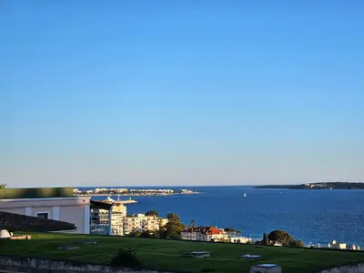 a view of the ocean and a golf course at Cannes - Superbe 2 pièces avec piscine - proche plages et centre in Cannes