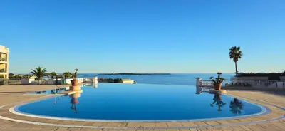 a swimming pool with a view of the water at Cannes - Superbe 2 pièces avec piscine - proche plages et centre in Cannes