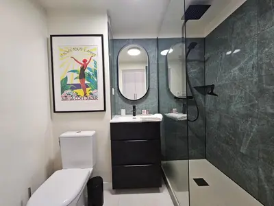 a bathroom with a toilet and a sink and a mirror at Cannes - Superbe 2 pièces avec piscine - proche plages et centre in Cannes