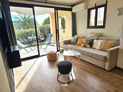 a balcony with two chairs and a table on a patio at Cannes - Superbe 2 pièces avec piscine - proche plages et centre in Cannes