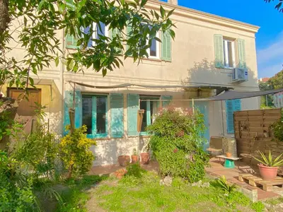 a living room with a couch and a table at Great flat! 12 minute walk from train station and Palais in Cannes