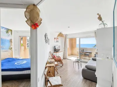 a bedroom with a bed and a living room at Beautiful apartment with sea view in Cannes 5 pers in Cannes