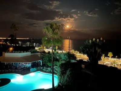 a view of a swimming pool at night at Beautiful apartment with sea view in Cannes 5 pers in Cannes