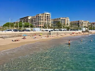 a group of people in the water at a beach at Beautiful apartment with sea view in Cannes 5 pers in Cannes
