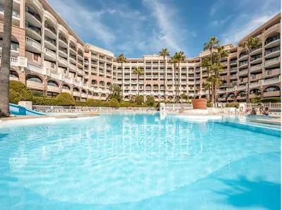 a large swimming pool in front of a large building at Beautiful apartment with sea view in Cannes 5 pers in Cannes