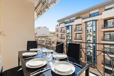 a dining room with a table and chairs on a balcony at Le Maubourg - Cannes terrasse near Beaches in Cannes