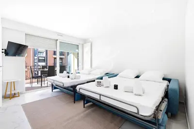 a room with two beds and a television in it at Le Maubourg - Cannes terrasse near Beaches in Cannes
