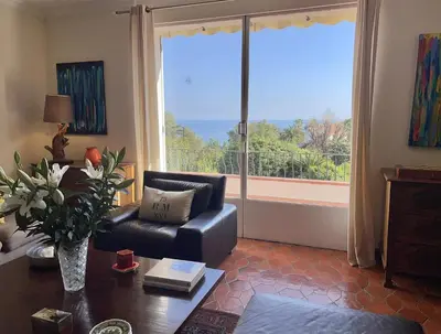 a living room with a couch and a table at Villa Roxane in Vallauris