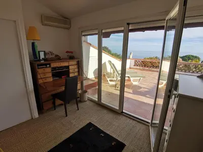 a living room with a couch and an umbrella at Villa Roxane in Vallauris