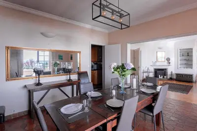 a dining room with a wooden table and chairs and a dining room at Villa Roxane in Vallauris