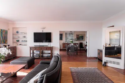 a living room with a couch and a tv at Villa Roxane in Vallauris