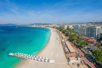 an aerial view of a beach with umbrellas and the ocean at Cosy a 3 min de la plage avec parking privé in Cannes