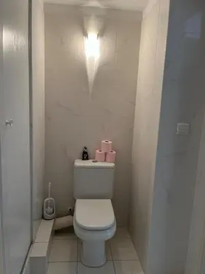a bathroom with a toilet with two pink boxes on it at Studio centre Cannes, piscine, climatisation in Cannes