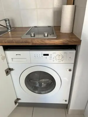 a washing machine in a kitchen with a counter at Studio centre Cannes, piscine, climatisation in Cannes