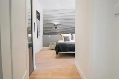 a bedroom with a bed in a room with a ceiling at 3 bedrooms 3 bath Bivouac 2 min Palais in Cannes