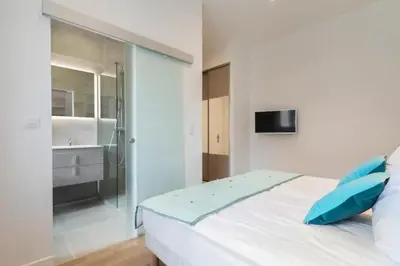 a bedroom with a bed with a shower and a sink at 3 bedrooms 3 bath Bivouac 2 min Palais in Cannes