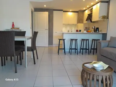a living room and kitchen with a couch and a table at Cannes Centre-Ville, Clim, WiFi 2-4P in Cannes