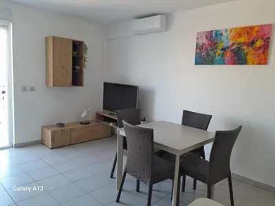 a dining room with a table and chairs and a tv at Cannes Centre-Ville, Clim, WiFi 2-4P in Cannes